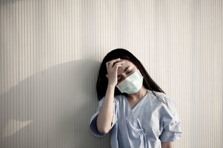 Asian patient woman wearing mask protect virus from sickness in hospitalの写真素材