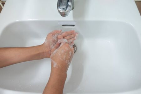 Little boy waiting for washing handの写真素材