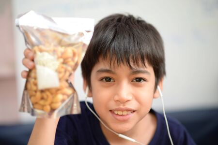 Little boys eating cashew nut healthy snack timeの写真素材