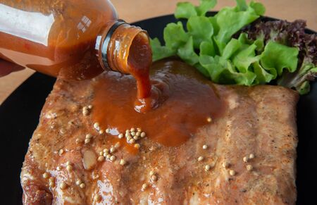 Pork rib grill with barbecue sauce on the plate の写真素材