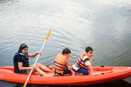 Family rowing kayak boat nature travel tripの写真素材