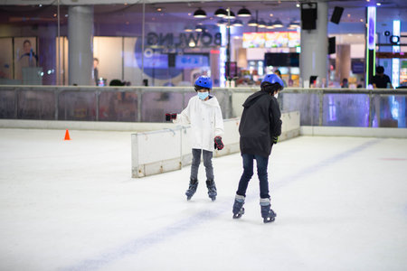 Asian teenager boy play ice skate indoorの写真素材