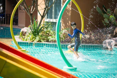 Happy family at water park on vacationの写真素材