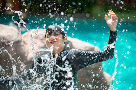 Asian family on vacation at  waterpark outdoor