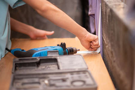 Boy teenager use screwdriver fix wood tableの写真素材