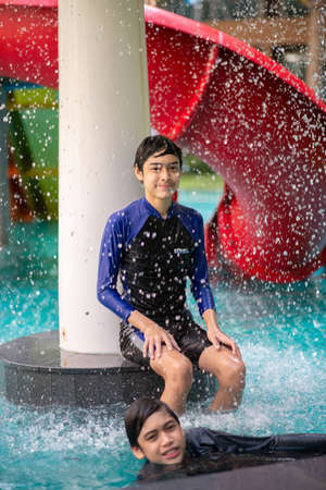 Asian family on vacation at  waterpark outdoorの写真素材