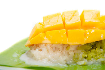 Mango with sticky rice topping with coconut milk sauceの写真素材