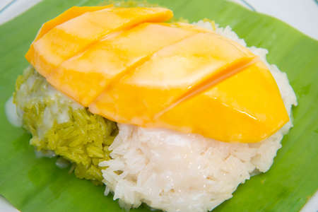 Mango with sticky rice topping with coconut milk sauceの写真素材