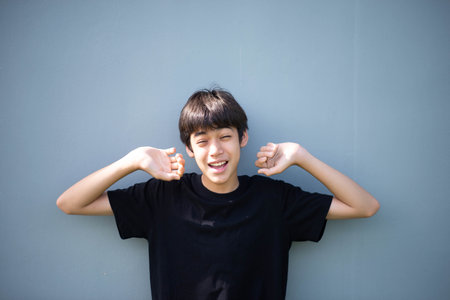 Teenage Boy's Expressions Collage: A captivating grid showcases a young Asian boy's diverse facial expressions, capturing a range of emotions from joy to contemplation.の写真素材