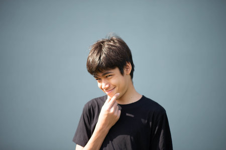 Teenage Boy's Expressions Collage: A captivating grid showcases a young Asian boy's diverse facial expressions, capturing a range of emotions from joy to contemplation.の写真素材