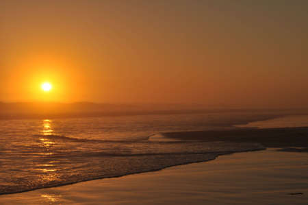 Sun setting over the sea の写真素材