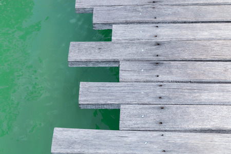 Closeup of a wooden bridge over the seaの写真素材