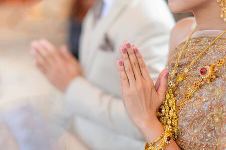 Thai traditional greeting with bride and groom hands, Thai wedding engagement ceremonyの写真素材