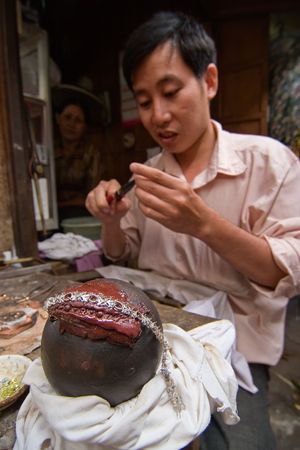 Phnom Penh, Cambodia, January 2, 2008, A jeweler making a braceletのeditorial素材