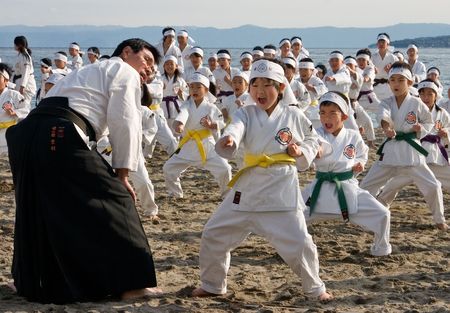 Kagoshima City, Japan, January 13, 2008. Young karate students performing kata on a beachのeditorial素材