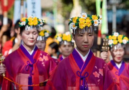 Kagoshima City, Japan, October 28, 2007. Women  in red yukata kimono and wearing flowers in their hair  lead a procession during the Taniyama Furusato Matsuri dance festival.のeditorial素材