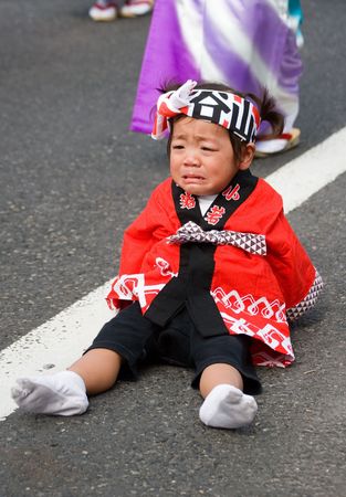  Kagoshima City, Japan, October 22, 2006. A tired young child dancer cries during the Taniyama Furusato Matsuri dance festival のeditorial素材