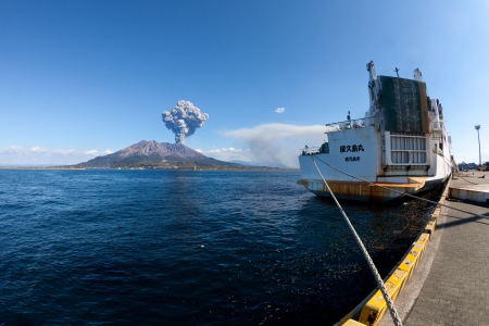KAGOSHIMA CITY, JAPAN - FEBRUARY 15: Mt Sakurajima erupting with a ship in foreground. The volcano erupted over 800 times in 2010, Kagoshima City, Japan, February 15, 2011. のeditorial素材