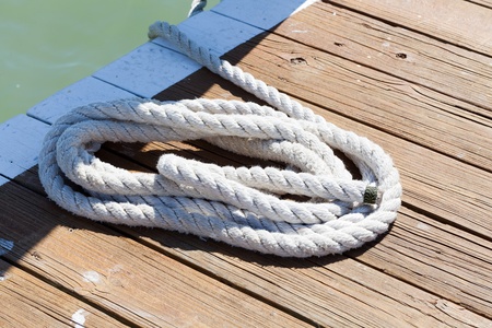 Rope on a post where the ship is tied up at the pier