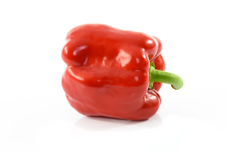 Ripe and fresh red pepper on a white background