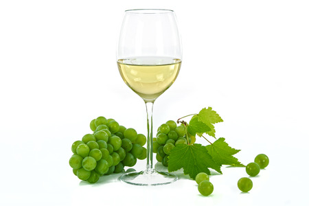 Ripe grapes and wine glass isolated on whiteの写真素材