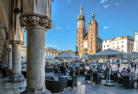 Krakow, Poland - July 07, 2016. Tourists relaxing on main market square in front of St. Mary's Basilica, in Krakow, Poland, Europe.のeditorial素材