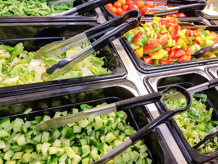 Concept of self-service bar or restaurant with a choice of different types of fruit and vegetable saladsの写真素材