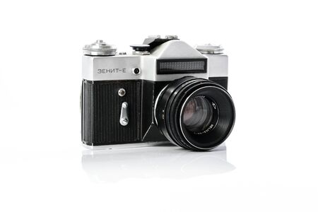 Krynica, Poland - December 29, 2017: Legendary Soviet 35 mm SLR camera Zenit-E with Helios 44mm lens isolated on white background in close-up.のeditorial素材