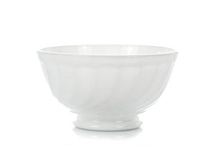 Elegant white porcelain bowl isolated on a white background in close-upの写真素材
