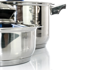 Culinary background - group of premium stainless steel pots and pans isolated on a white background with copy place.の写真素材