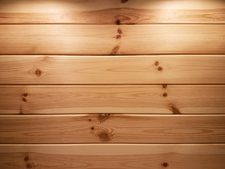 Beautiful wooden background - natural spruce planks with two backlights illuminated from above as a texture (high details).の写真素材