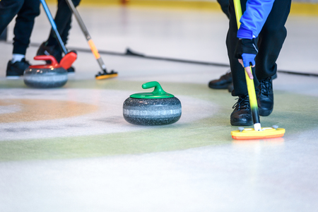 Team members play in curling at the championship.の写真素材