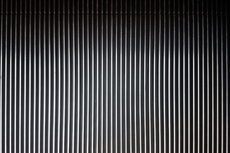 Textured background of striped pattern of a metal escalator in close-up