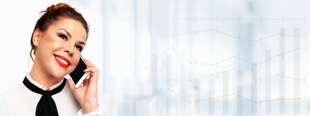 Modern business communications banner -  beautiful young business woman talking on a mobile phone and smiling on a abstract big data background (copy space).の写真素材
