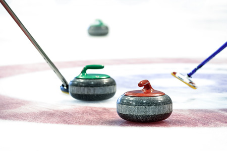 Curling stones equipment on the ice in close-up.の写真素材