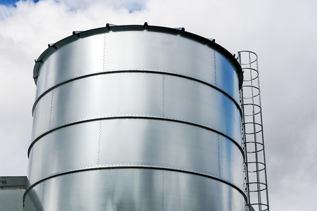 Agriculture Industry equipment - large modern silo for storing grain harvest in close-up.の写真素材