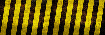 Grunge metal yellow hazard stripe texture background for wide bannerの写真素材