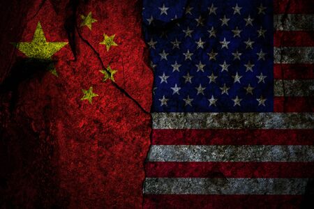 Composite image of US flag and China flag on the cracked rocky wall as a trade conflict conceptの写真素材