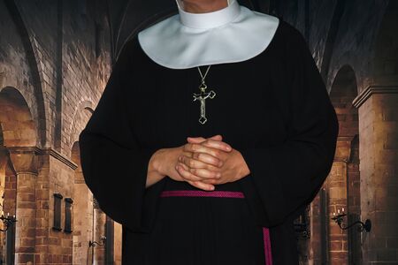 Religious life concept - unrecognized nun prays in the archival medieval monastery (mixed)