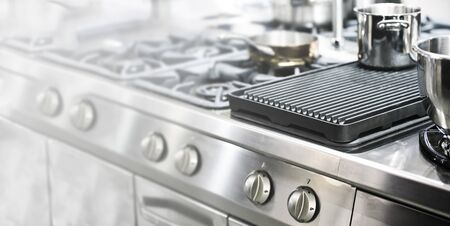 Wide culinary industry banner - part of a modern kitchen in the restaurant or hotel with professional equipments (copy space)の写真素材