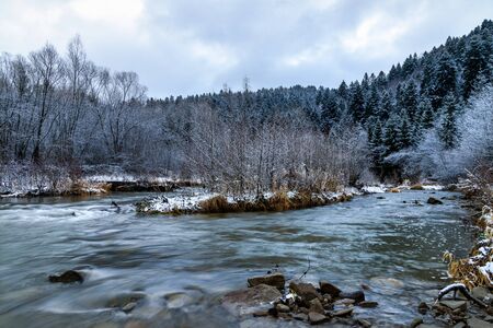 December nature scenery landscape - picturesque river among mountains and frosted trees at daybreak (HDR photo merge)の写真素材