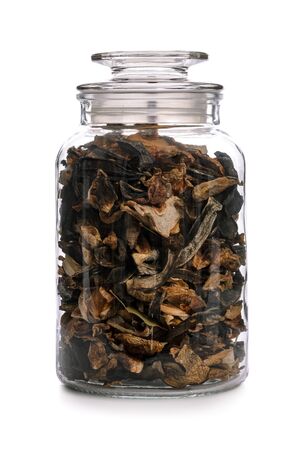 Concept image of homemade preserves - vintage jar of dried mushrooms with herbs isolated on a white background (high details)の写真素材