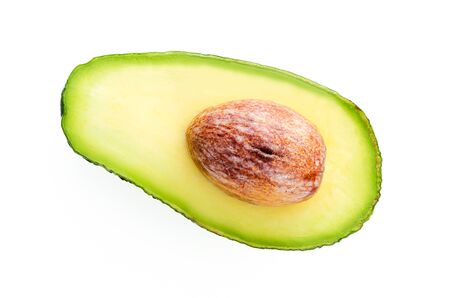 Top view of single fresh avocado slice with core isolated on a white background in close-up. 