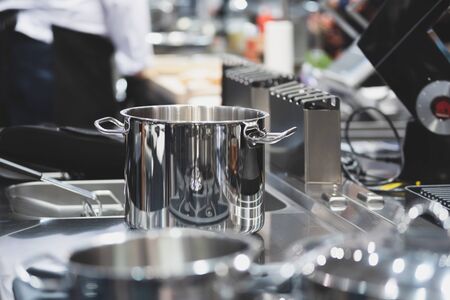 Interior view of a professional kitchen in a restaurant or hotel with selective focus on stainless...