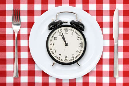 Time to Eating or Intermittent fasting concept - flat lay composition with alarm clock, plate and...