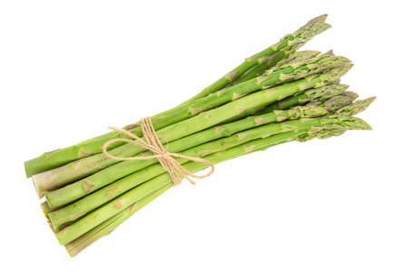 Close-up of a fresh raw asparagus bunch tied with a burlap twine isolated on a white backgroundの写真素材