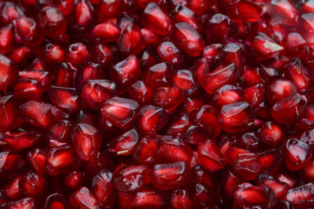 Full frame macro shot background of pomegranate peeled ripe seedsの写真素材