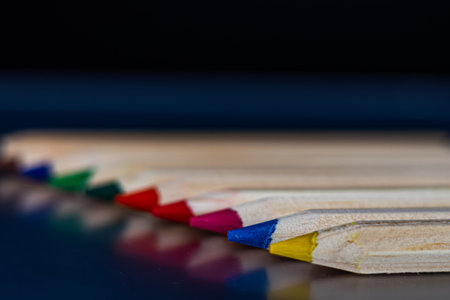 Colored pencils on a black background. Selective focus.の写真素材