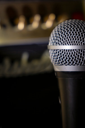 Close up of a microphone on a black background with copy space.