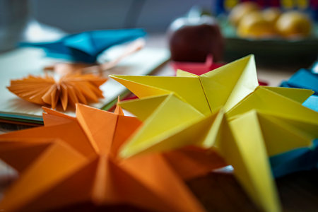 Colorful origami made from paper on a wooden table in a workshop